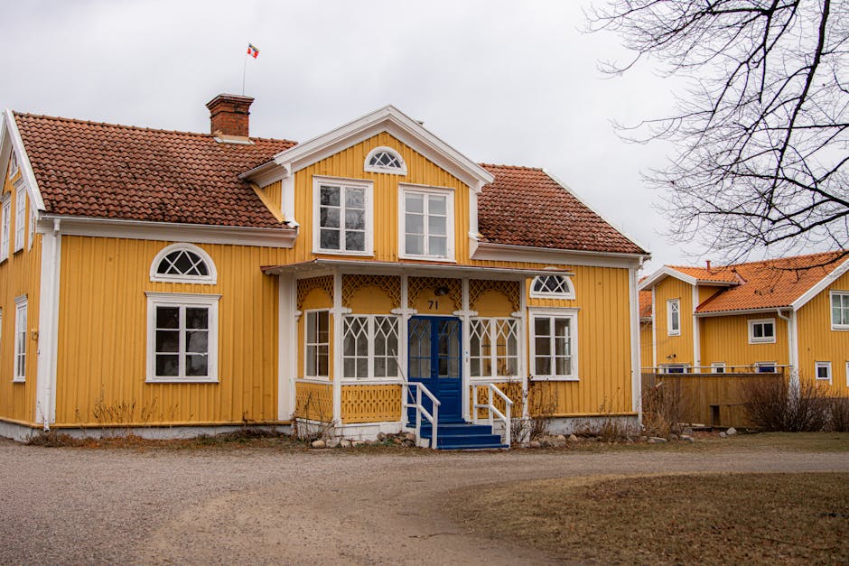 Quaint Swedish country house with vibrant yellow exterior and classic Nordic architecture.