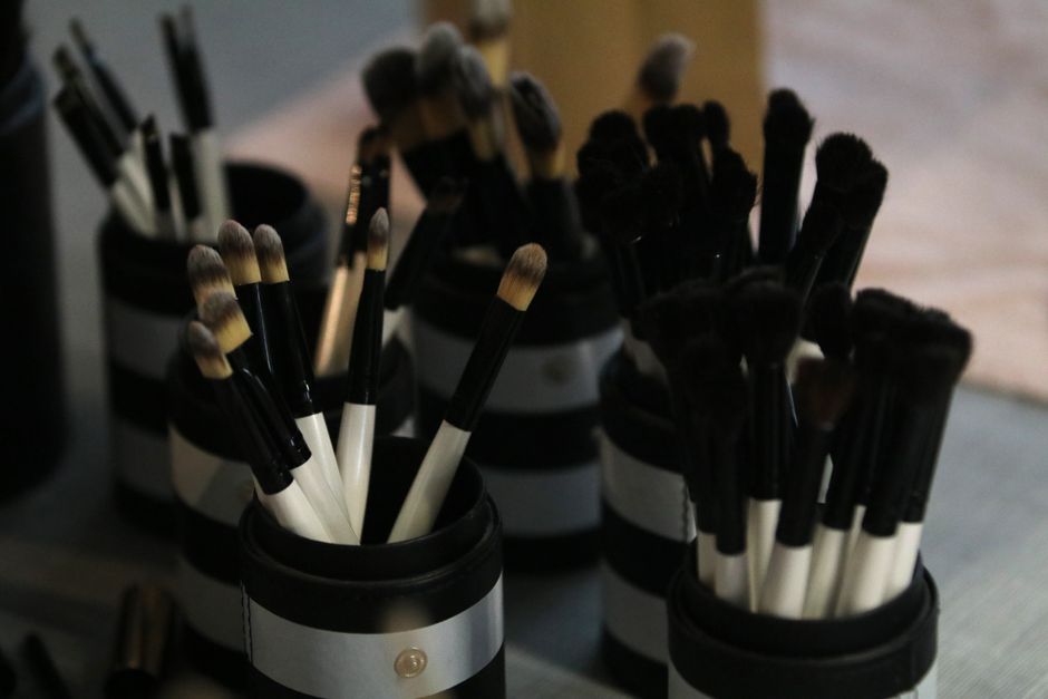 A close-up view showcasing a collection of makeup brushes neatly arranged in holders.