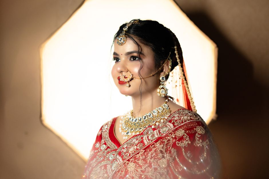 A stunning Indian bride adorned in a traditional red lehenga, showcasing grace and elegance.