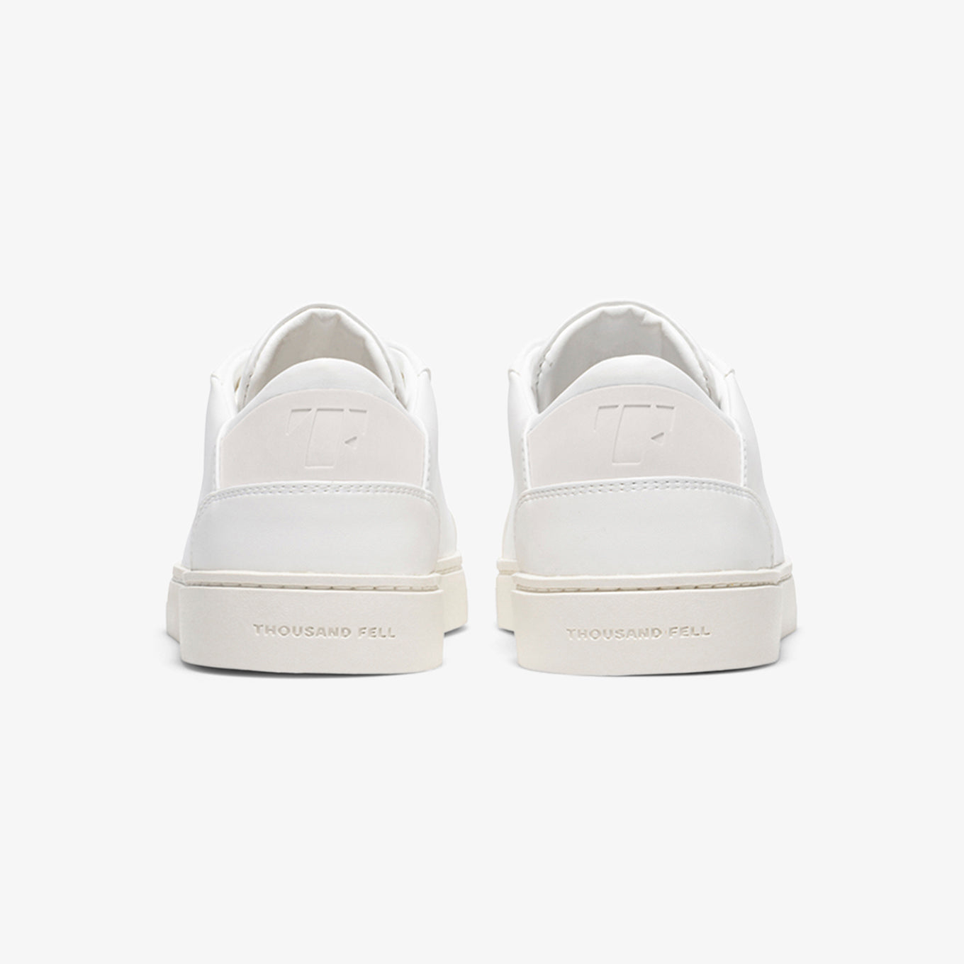 White lace up sneaker angle showing the clean sole and upper